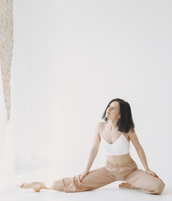 Woman meditating in a peaceful yoga pose, soft light.